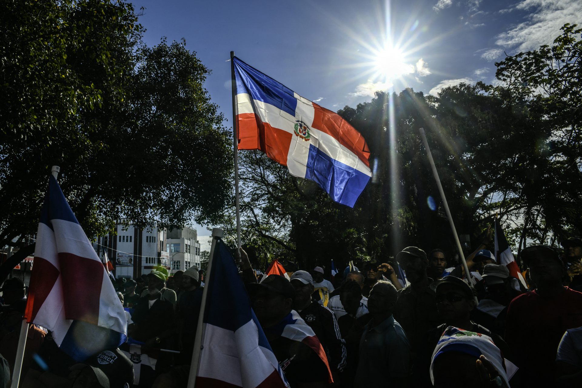 A person holds a flag at a rally.