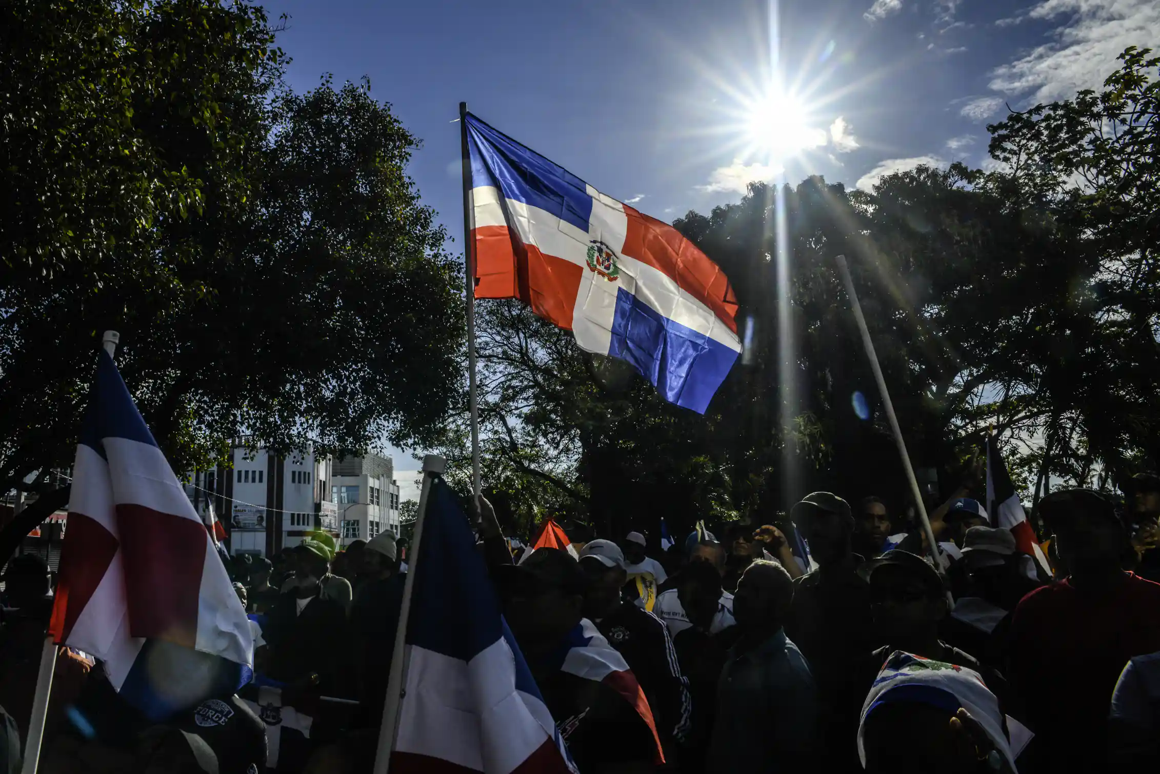 A person holds a flag at a rally.