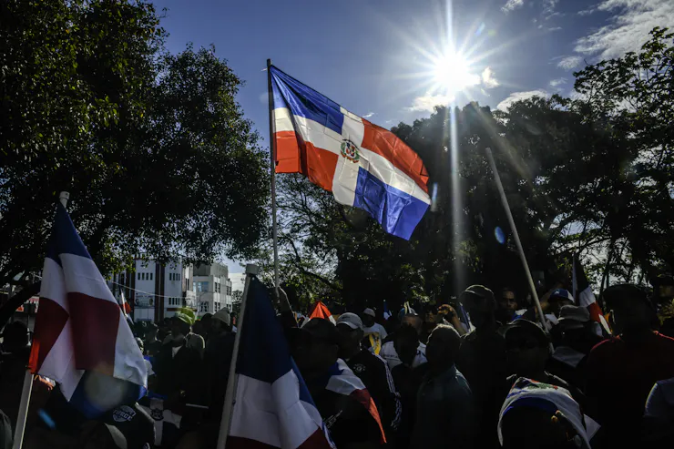 A person holds a flag at a rally.