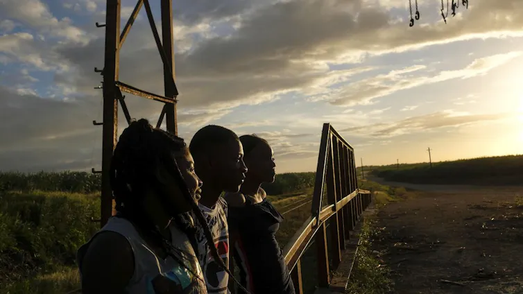 Young people look at a sunset.