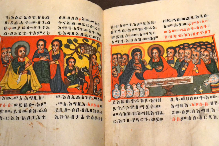Magdala Gospel – an open manuscript showing illustration of Jesus and disciples