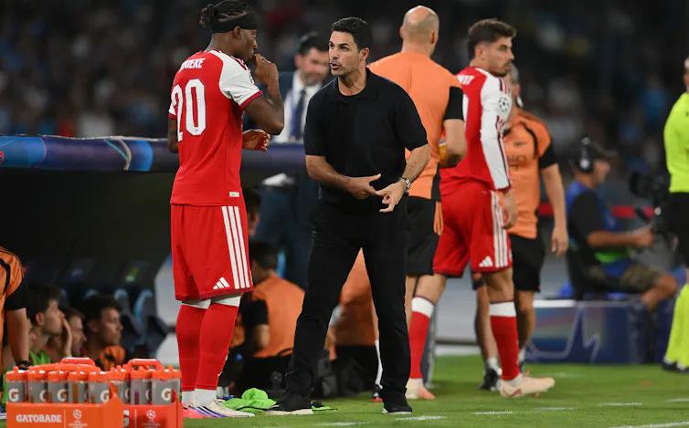 Mikel Arteta talks to Arsenal player Noni Madueke during their Champions League victory over Napoli on September 9 2026.