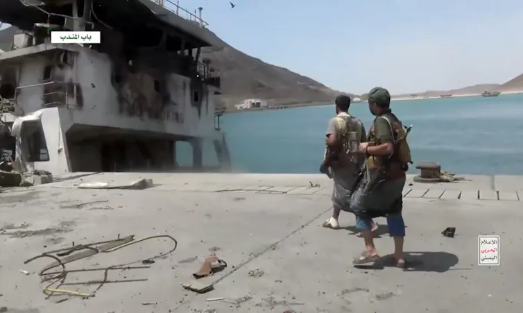 A screengrab taken from a video shows two Houthi fighters in the coastal town of Dhubab.