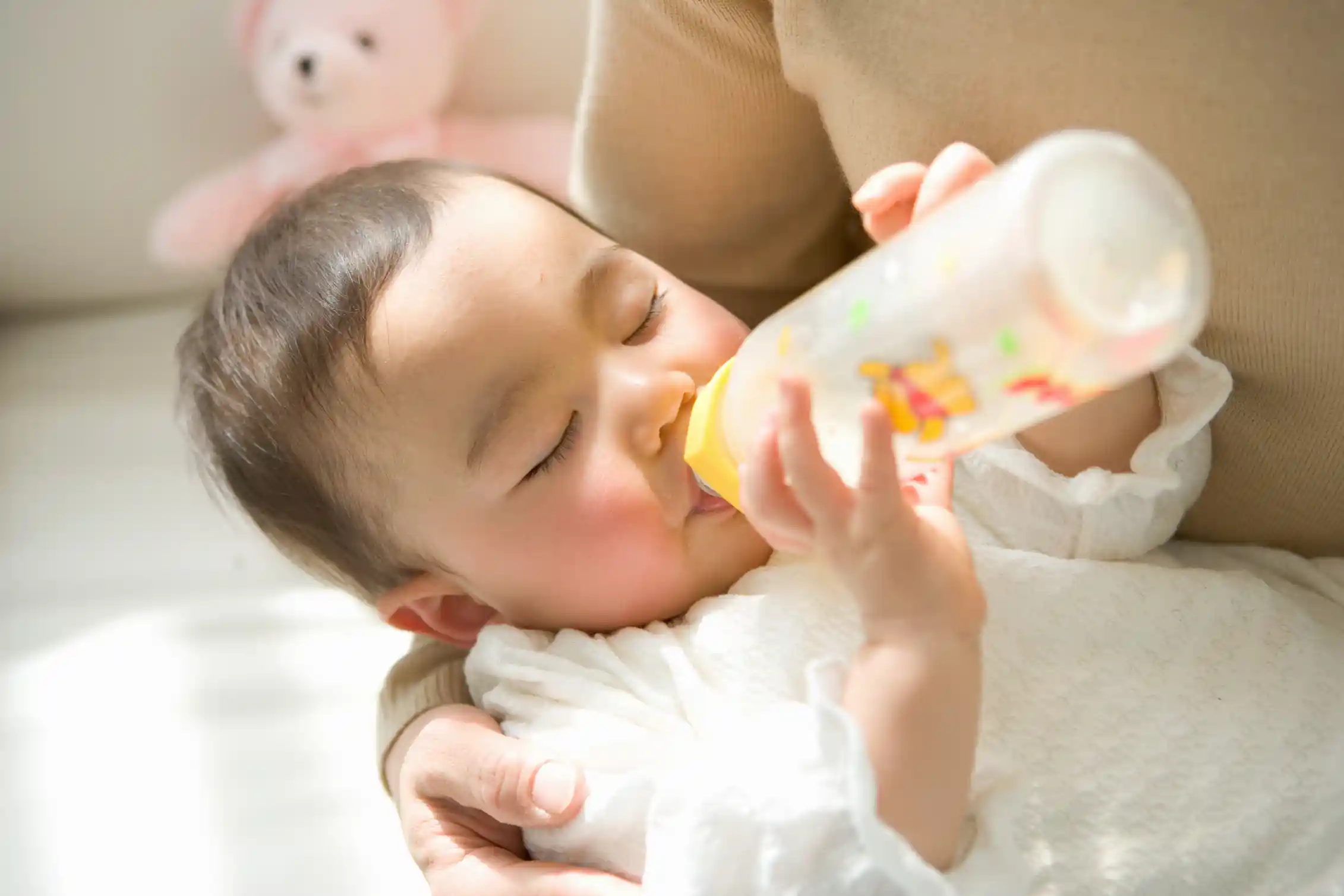 Baby holding a bottle