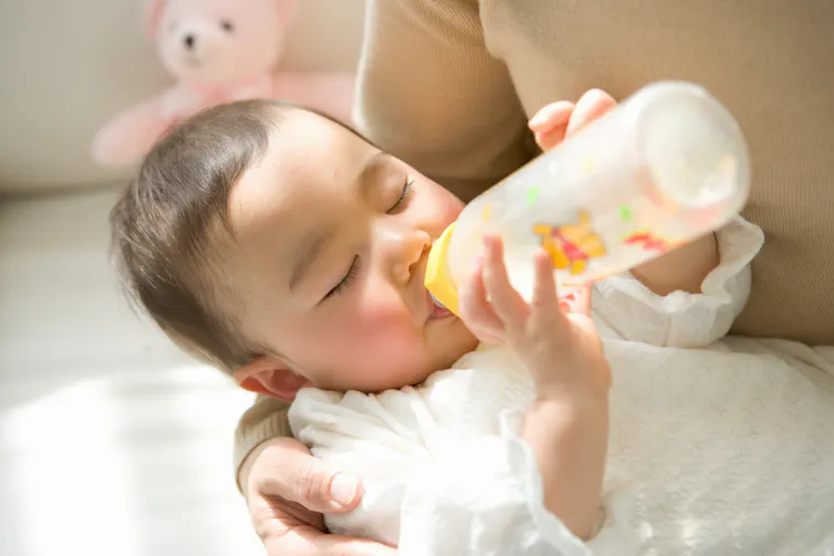 Baby holding a bottle