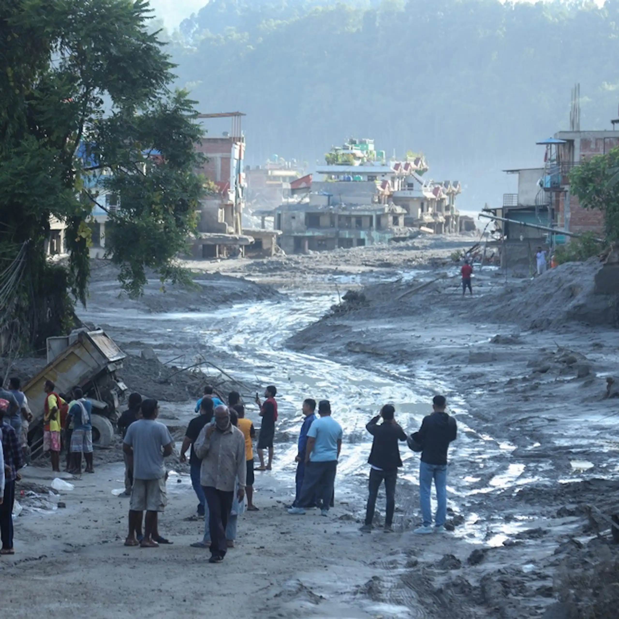 People looking at the result of massive floods in Nepal.