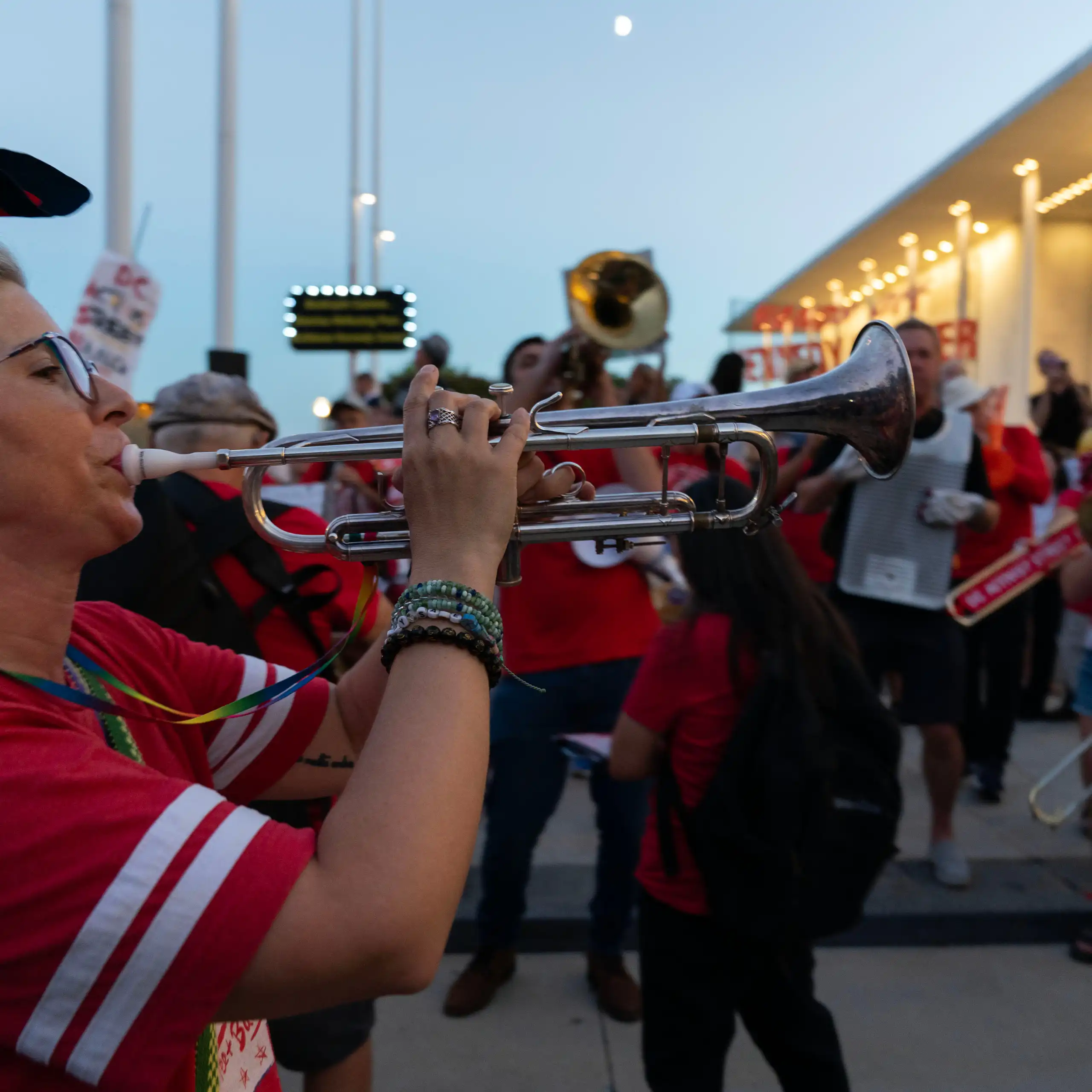 Musicians perform during a rally in front of a big building.