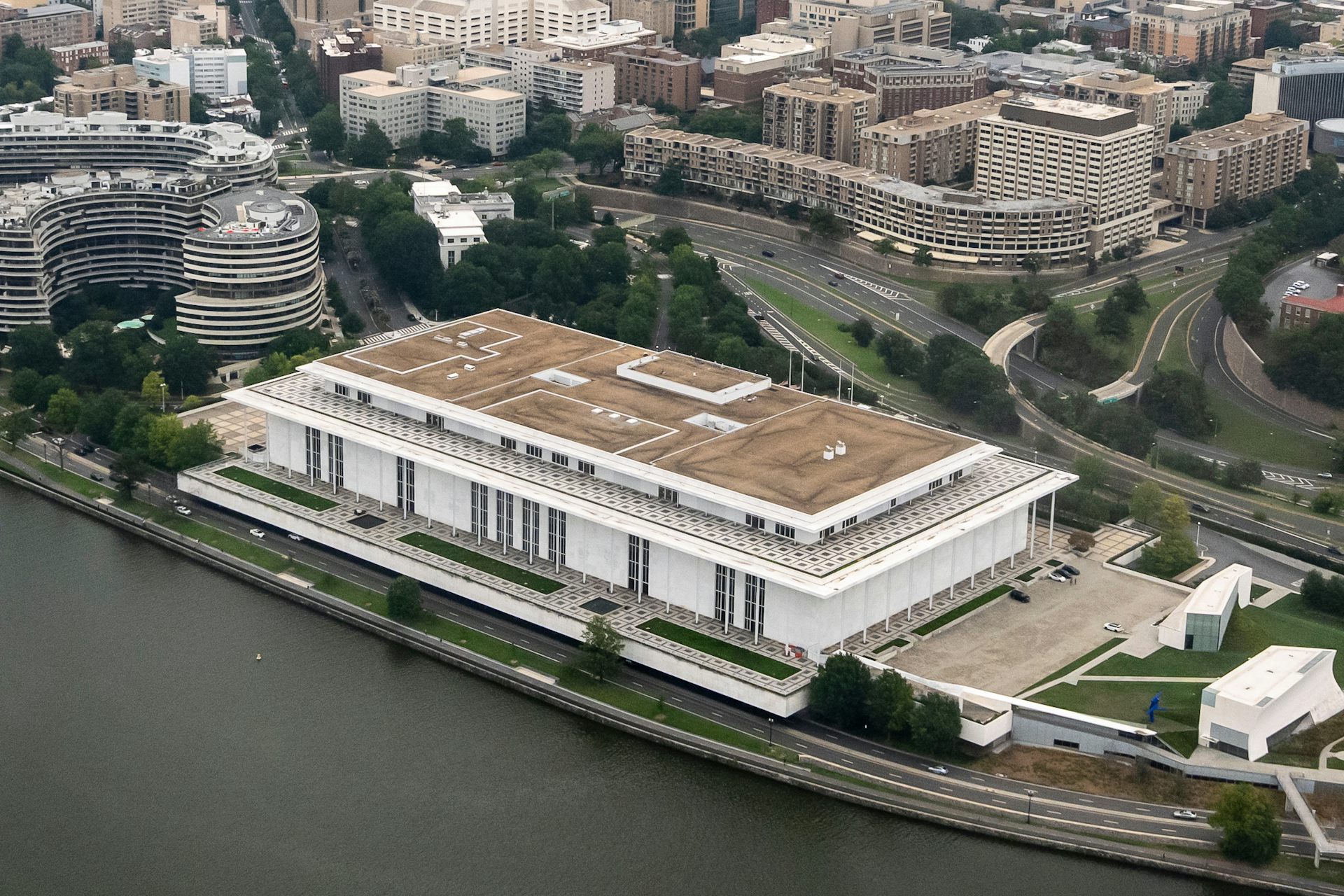 A large building faces a river.