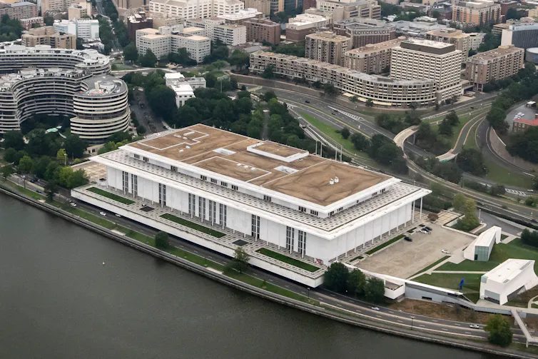 A large building faces a river.