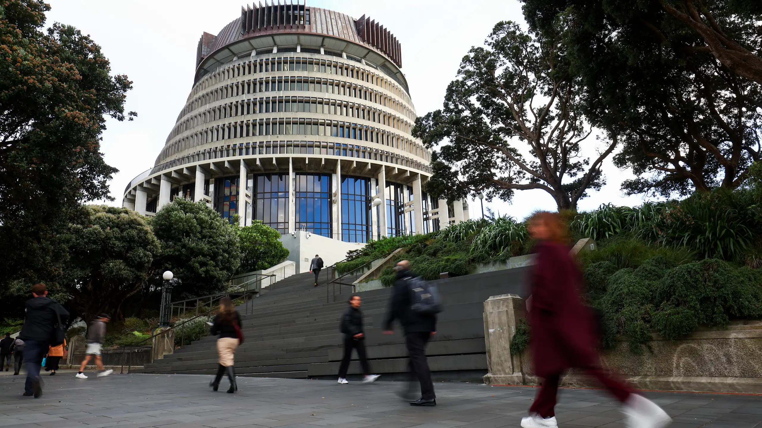 People walking beside Beehive government building