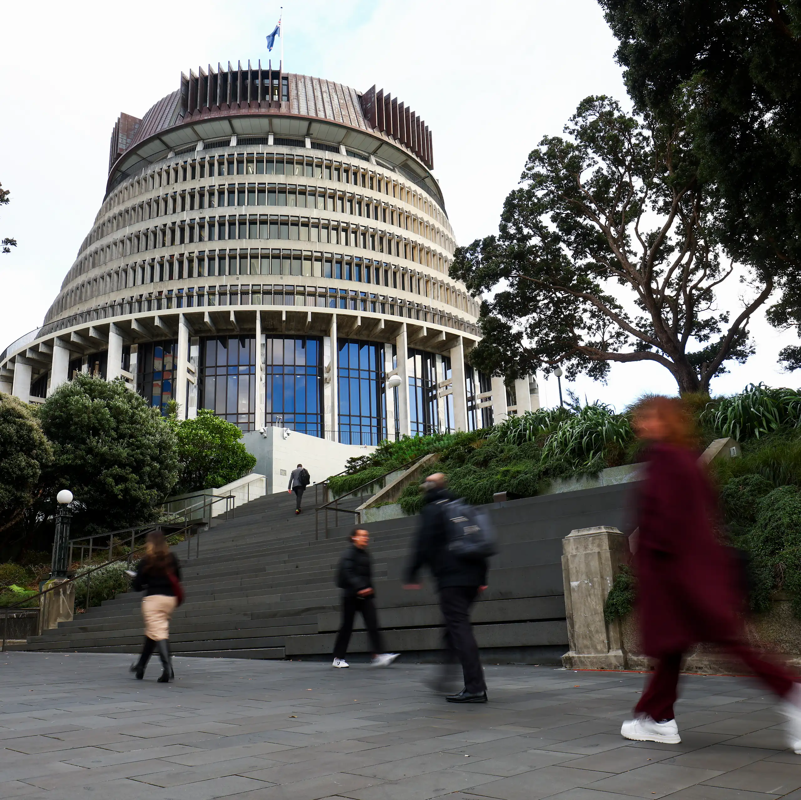 People walking beside Beehive government building
