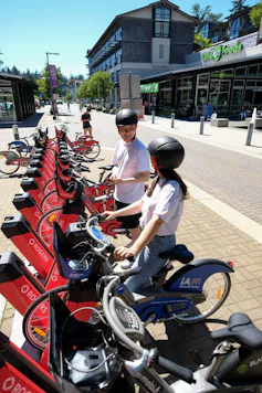 two people among a row of bicycles