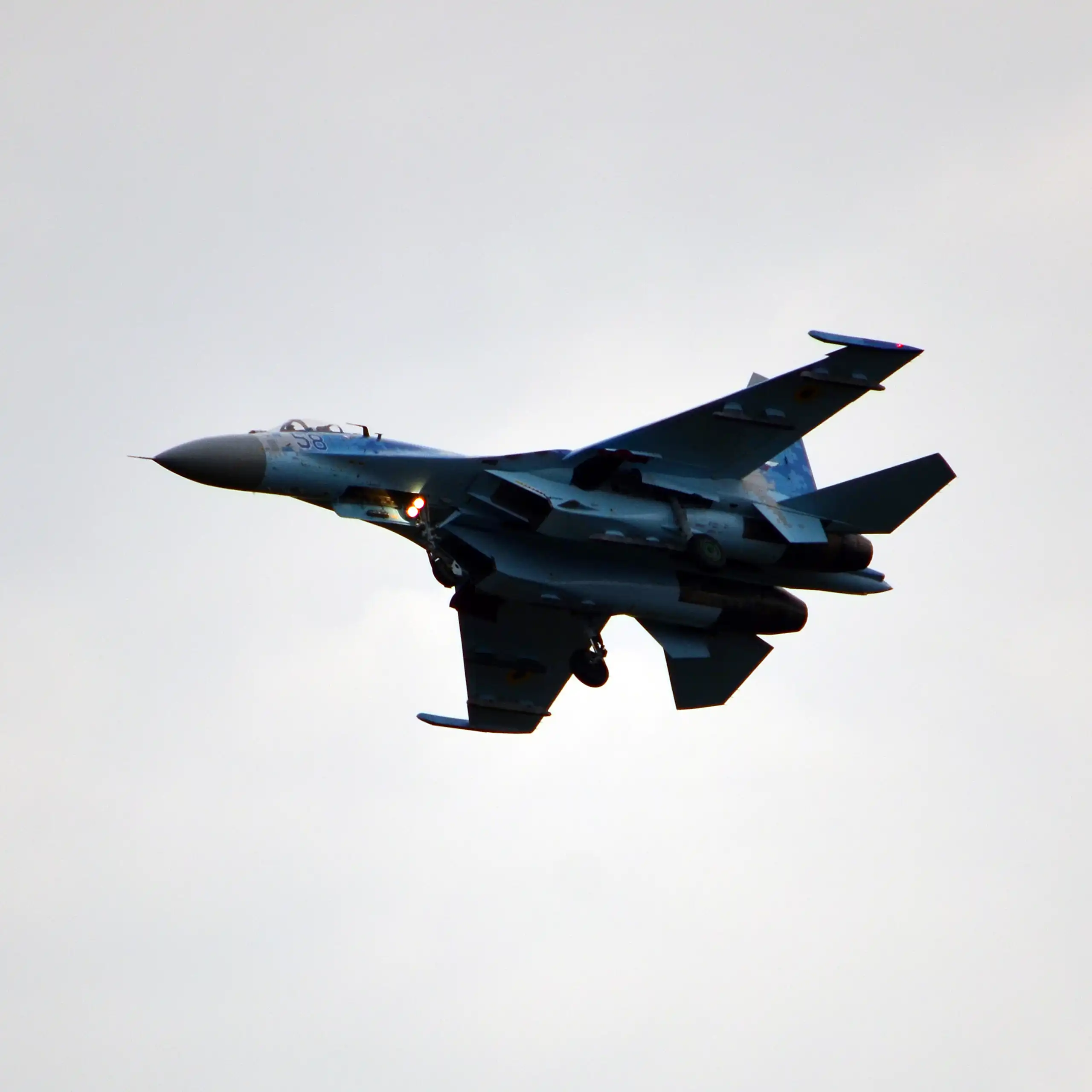 A fighter jet belonging to the Ukrainian Air Force flies through the sky.