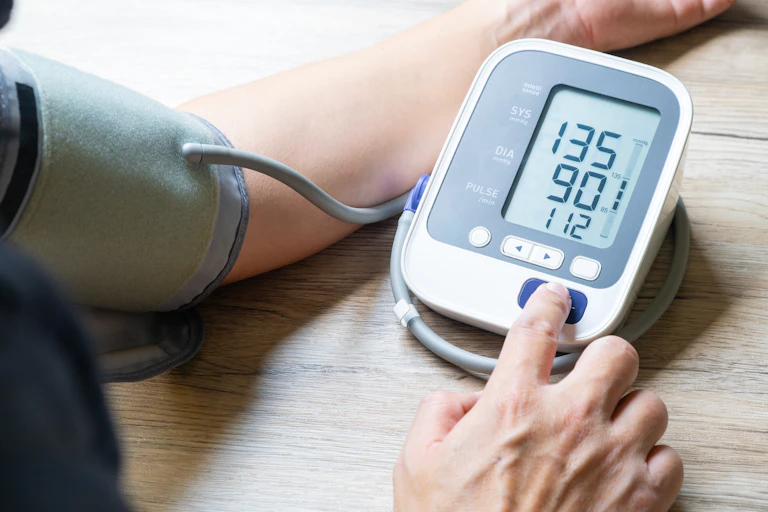 A person measuring their blood pressure.