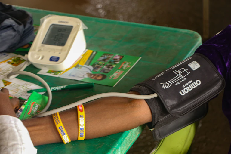 Person's arm with blood pressure cuff and monitor