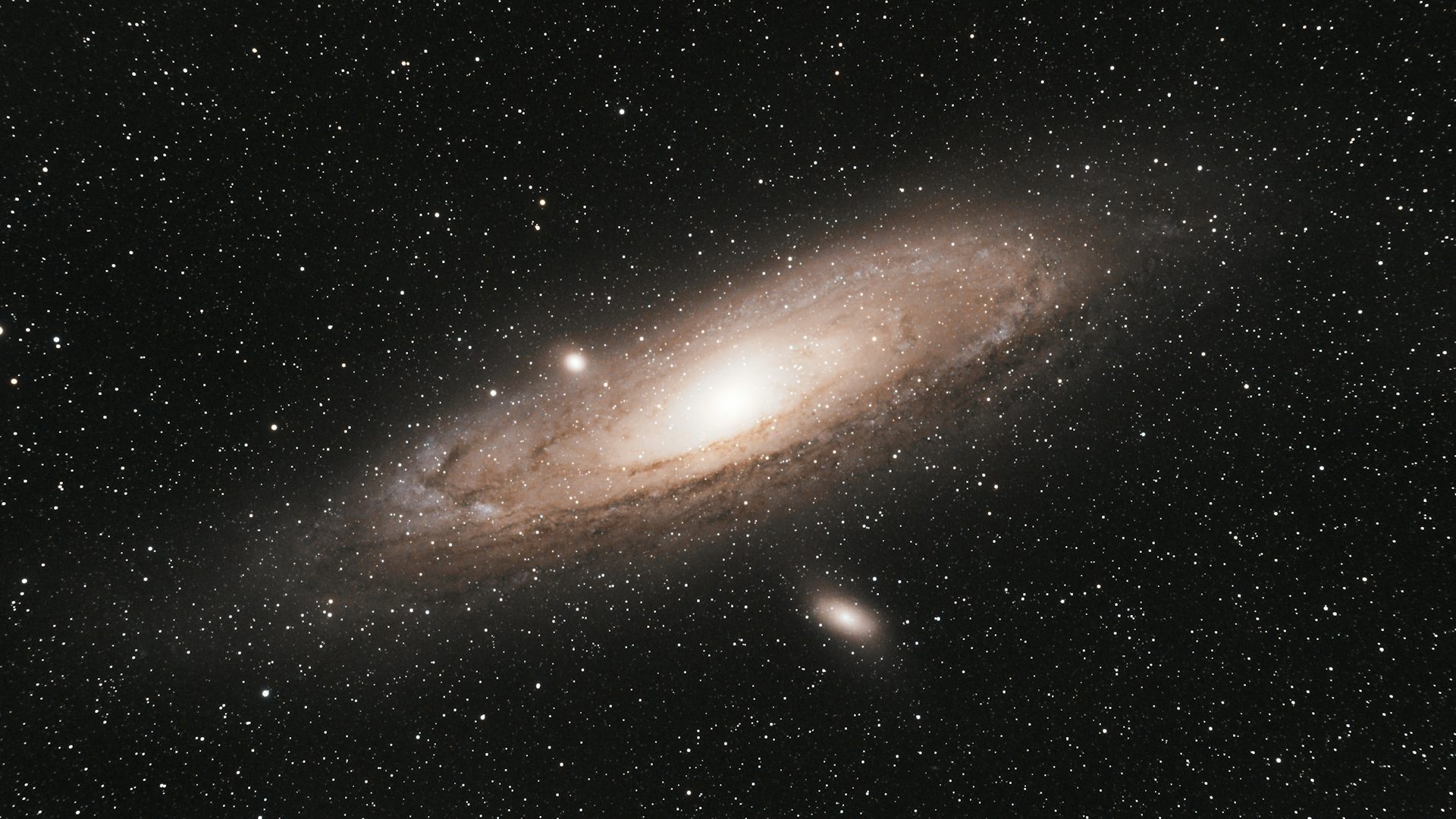 Bright oval shaped galaxy in starry sky.