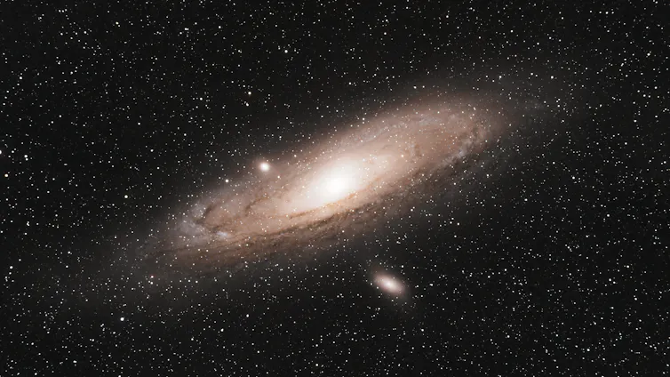 Bright oval shaped galaxy in starry sky.