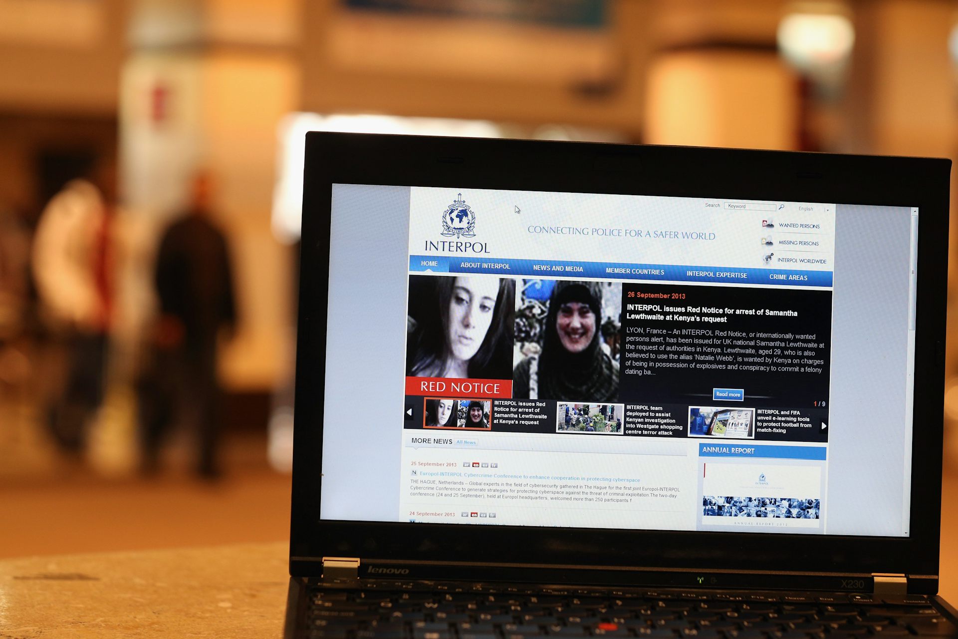 A laptop shows a page with a woman's face on it.