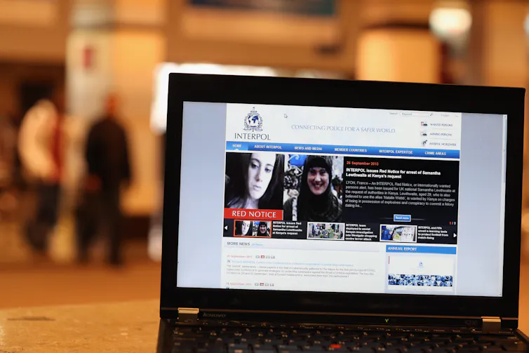 A laptop shows a page with a woman's face on it.