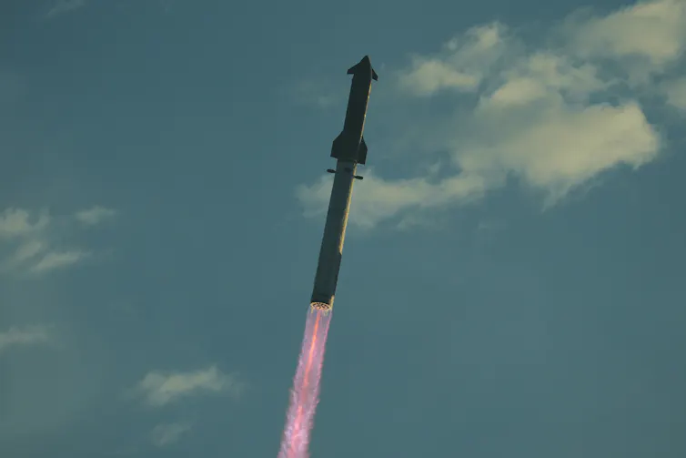 A rocket flying through the sky, propelled by a streak of flame