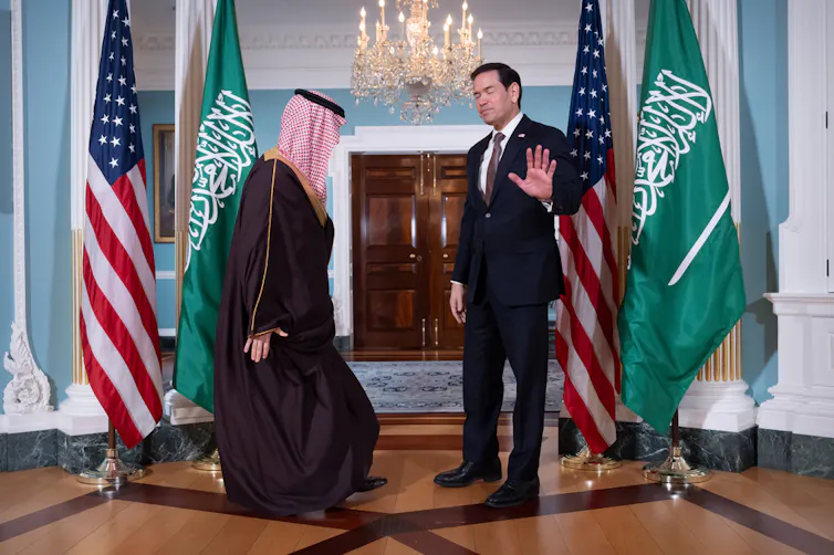 Two men gather a diplomatic meeting.