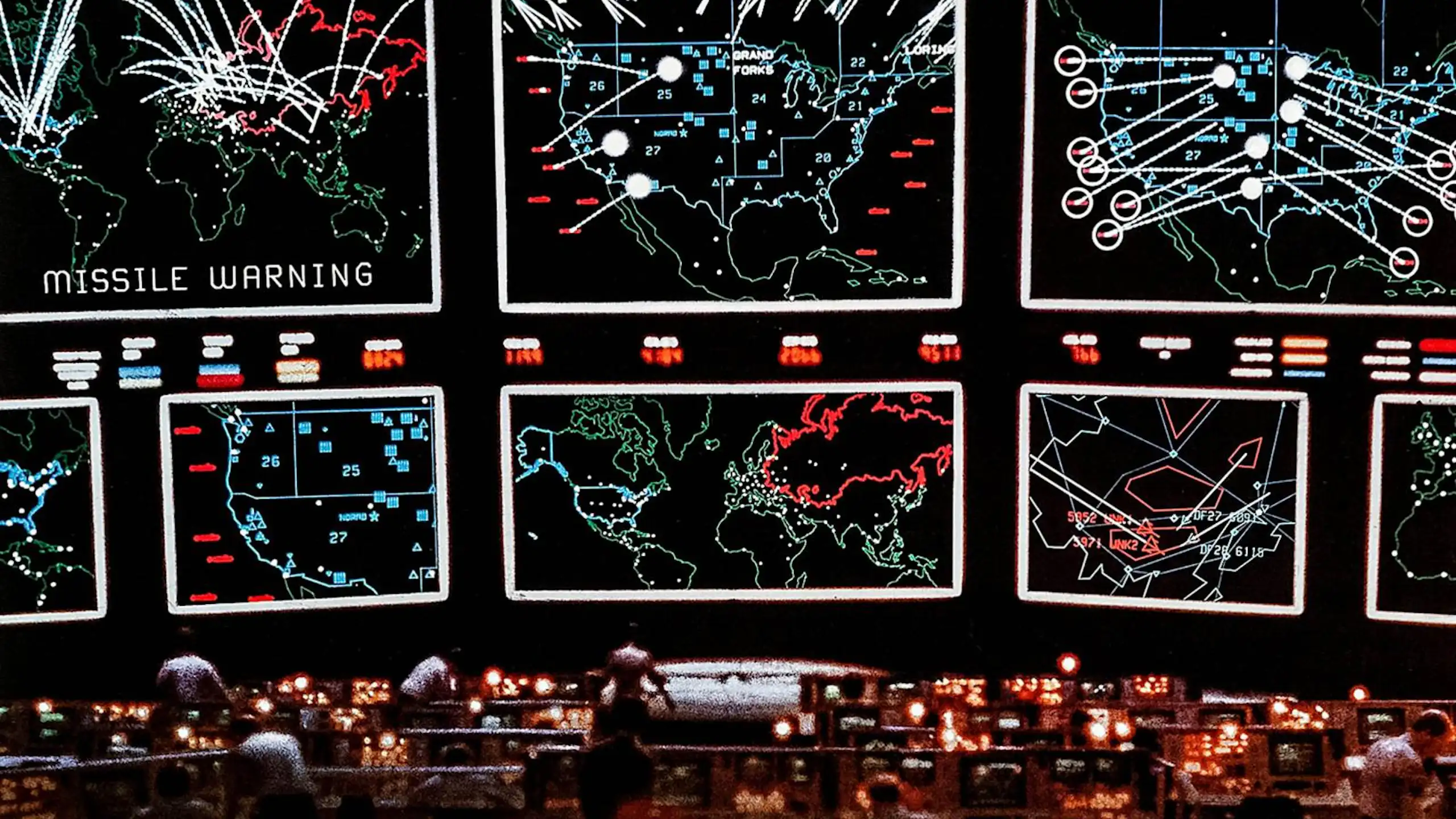 a dark room with a set of very large display screens