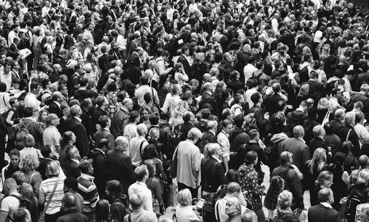 A black and white photo of a large crowd of people
