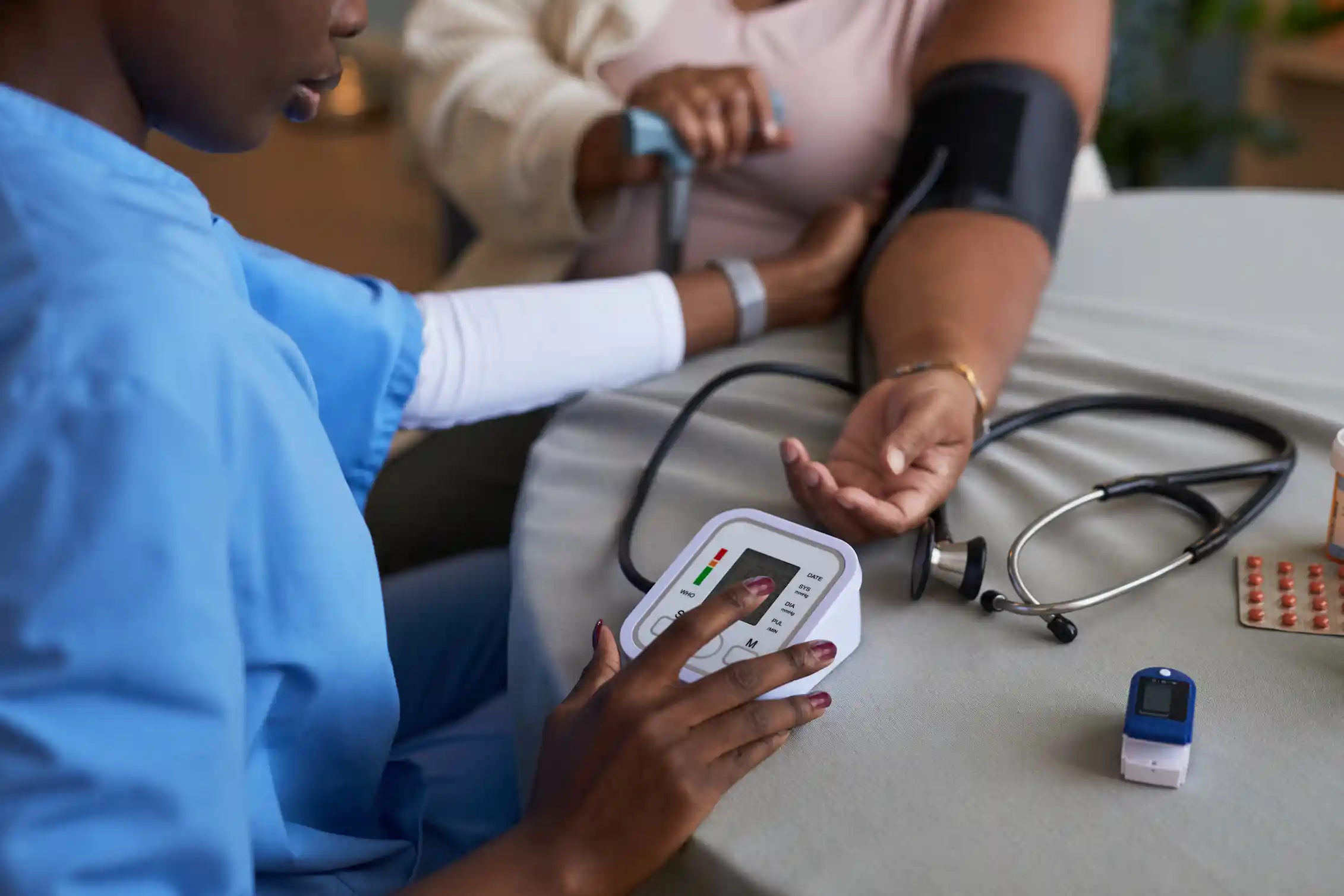 Clinician collecting blood pressure reading from a patient