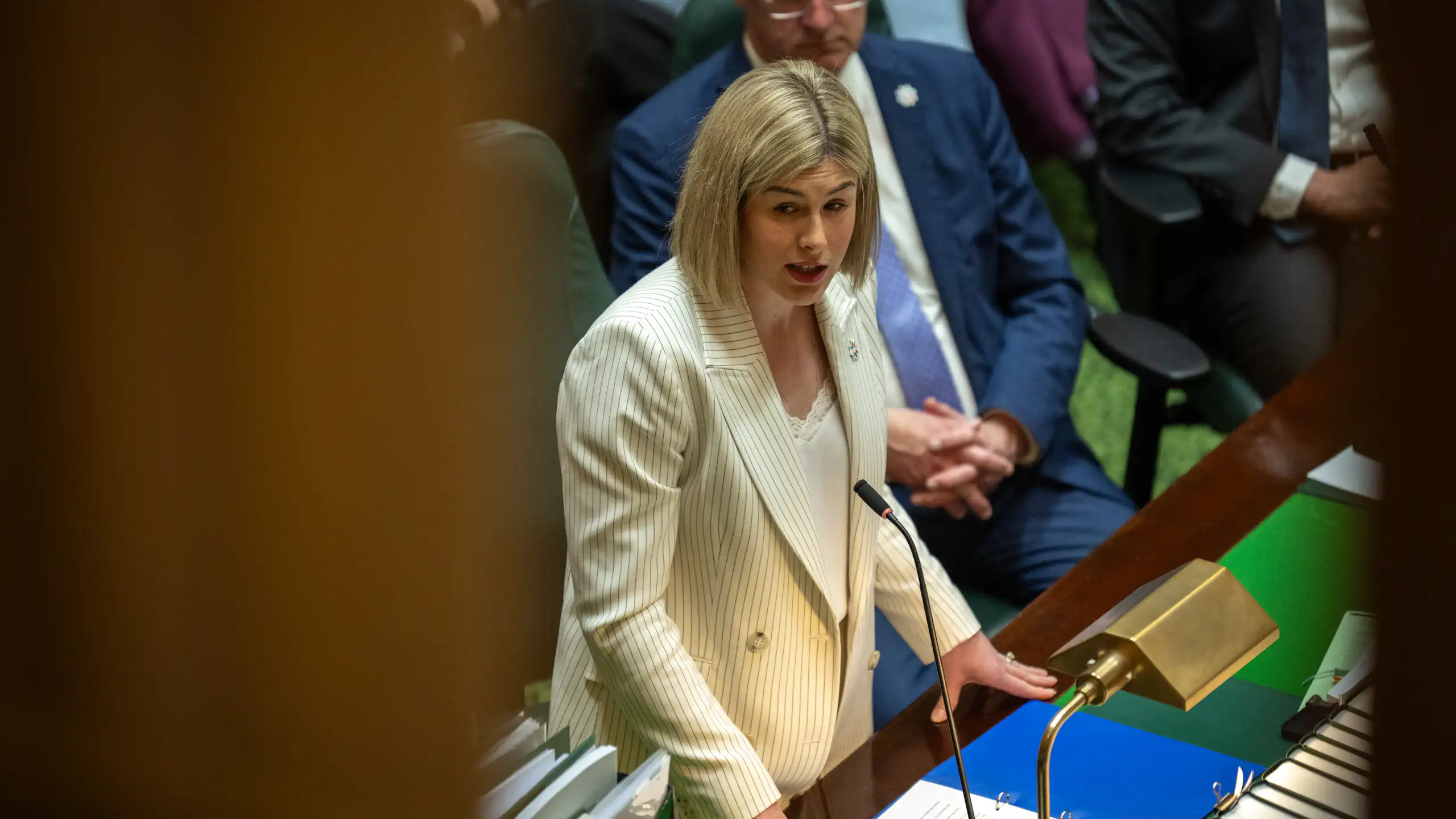 A woman stands up in parliament and delivers a speech