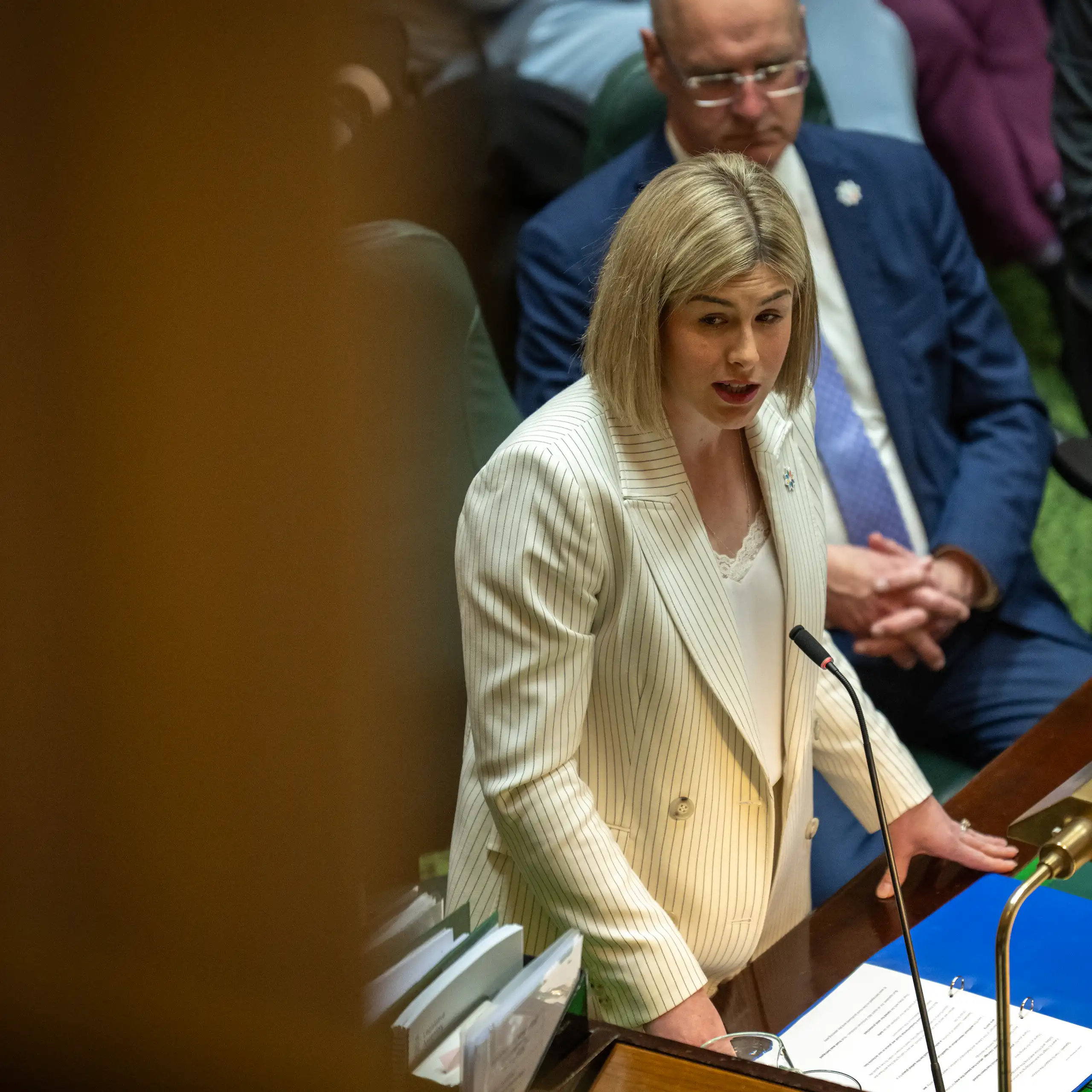 A woman stands up in parliament and delivers a speech