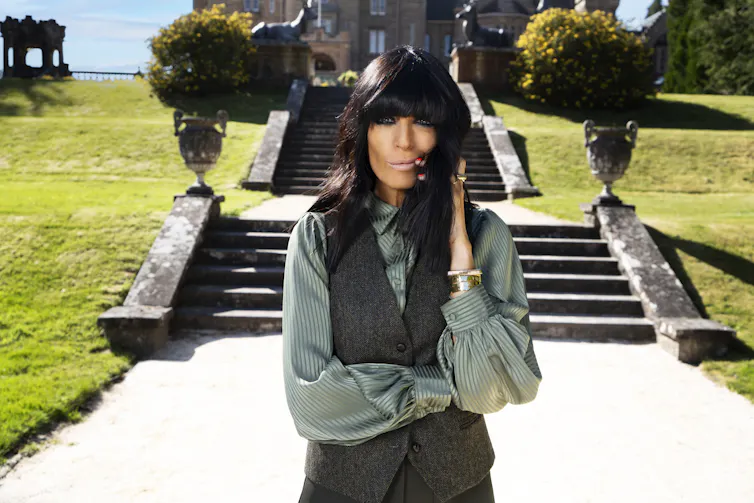 Claudia Winkleman standing in front of steps