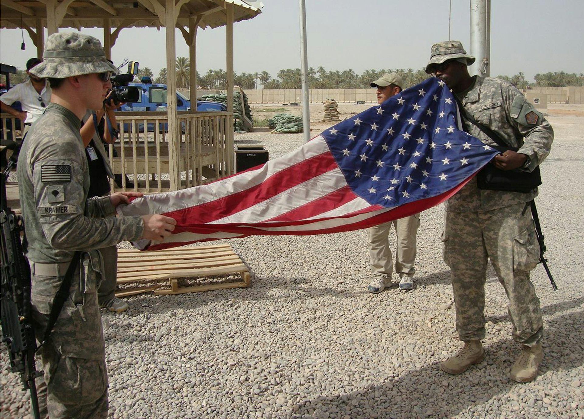 US soldiers in Iraq fold a flag