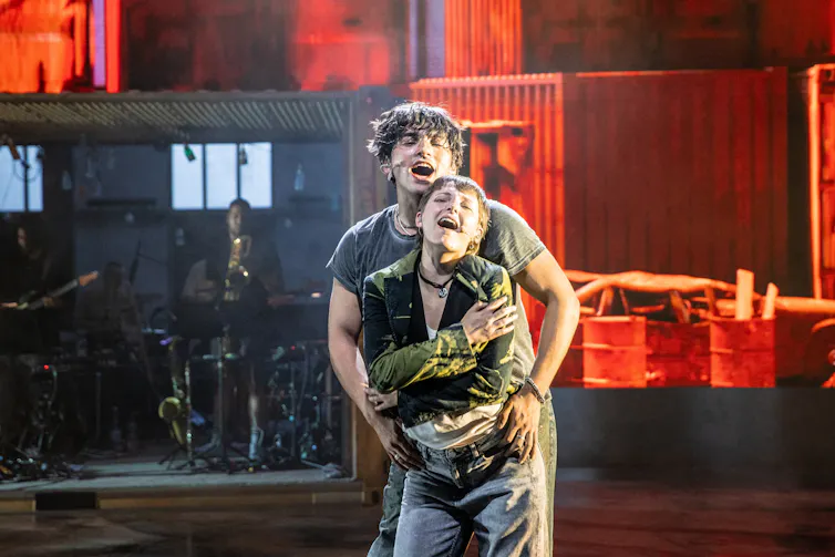 Two actors on stage embracing