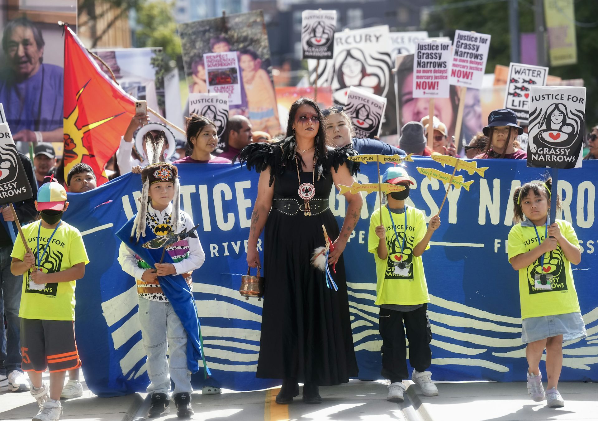 People seen with signs protesting mercury poisoning. 