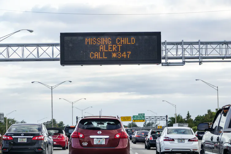 missing child alert text on a digital highway sign