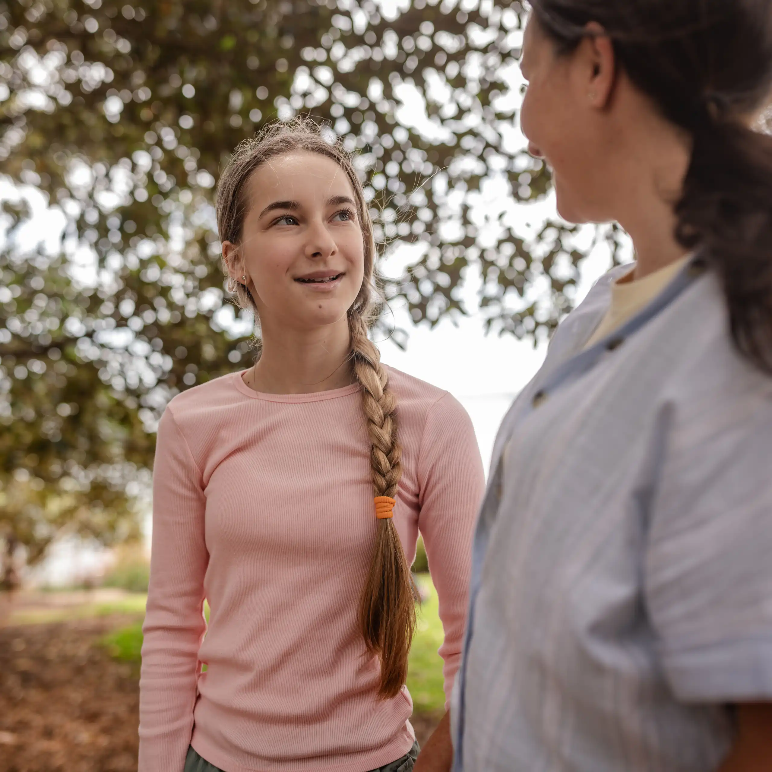 A mother and daughter spending time outside together.