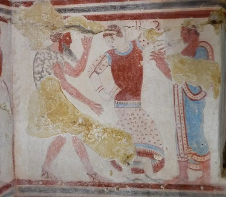 Paintings of dancers inside the Tomba del Gallo.