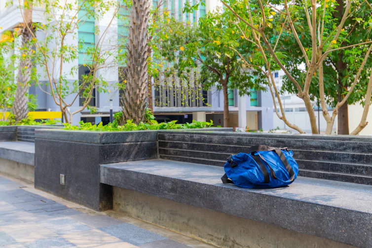 abandoned blue bag on a bench in a moden urban area