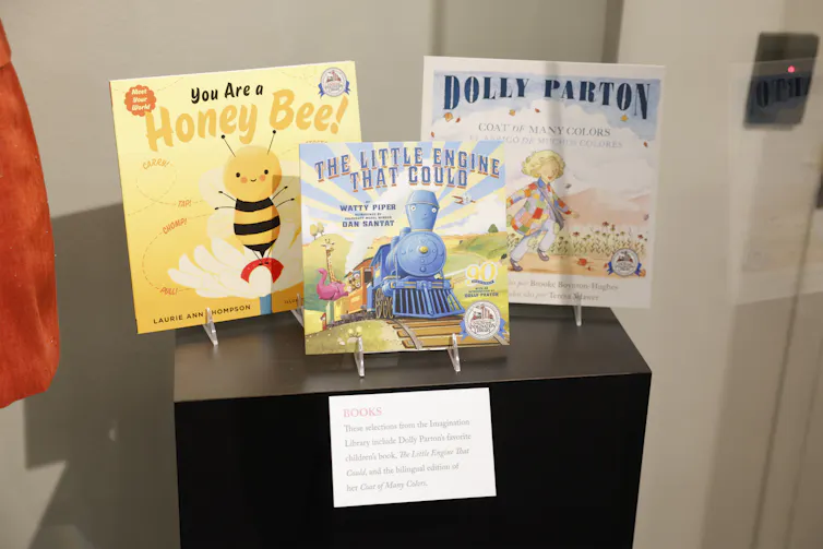 Three children's books are seen on display, including one in English and Spanish by Dolly Parton.