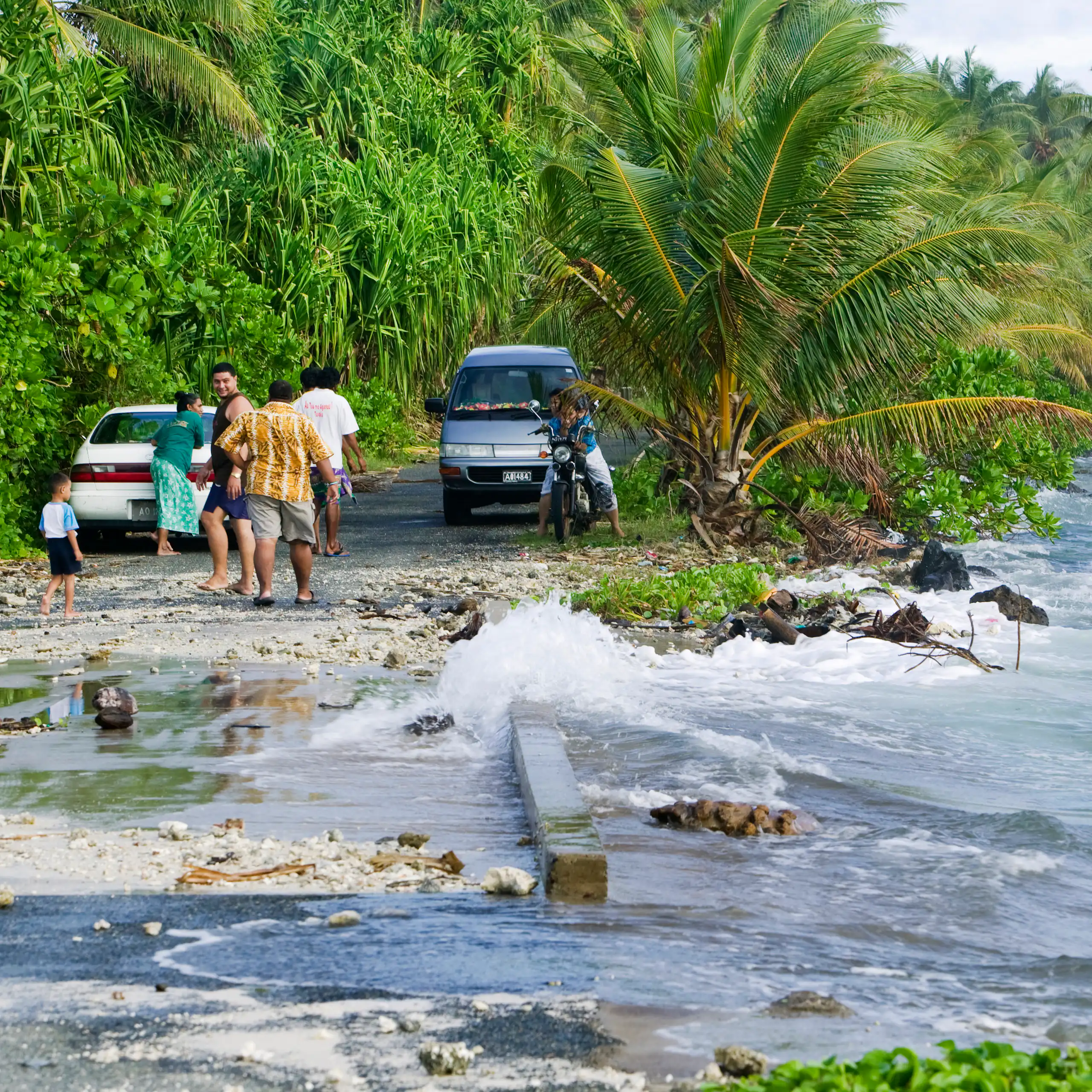 Tuvaluans watch as the high tide inundates their island home on funafuti due to global warming.