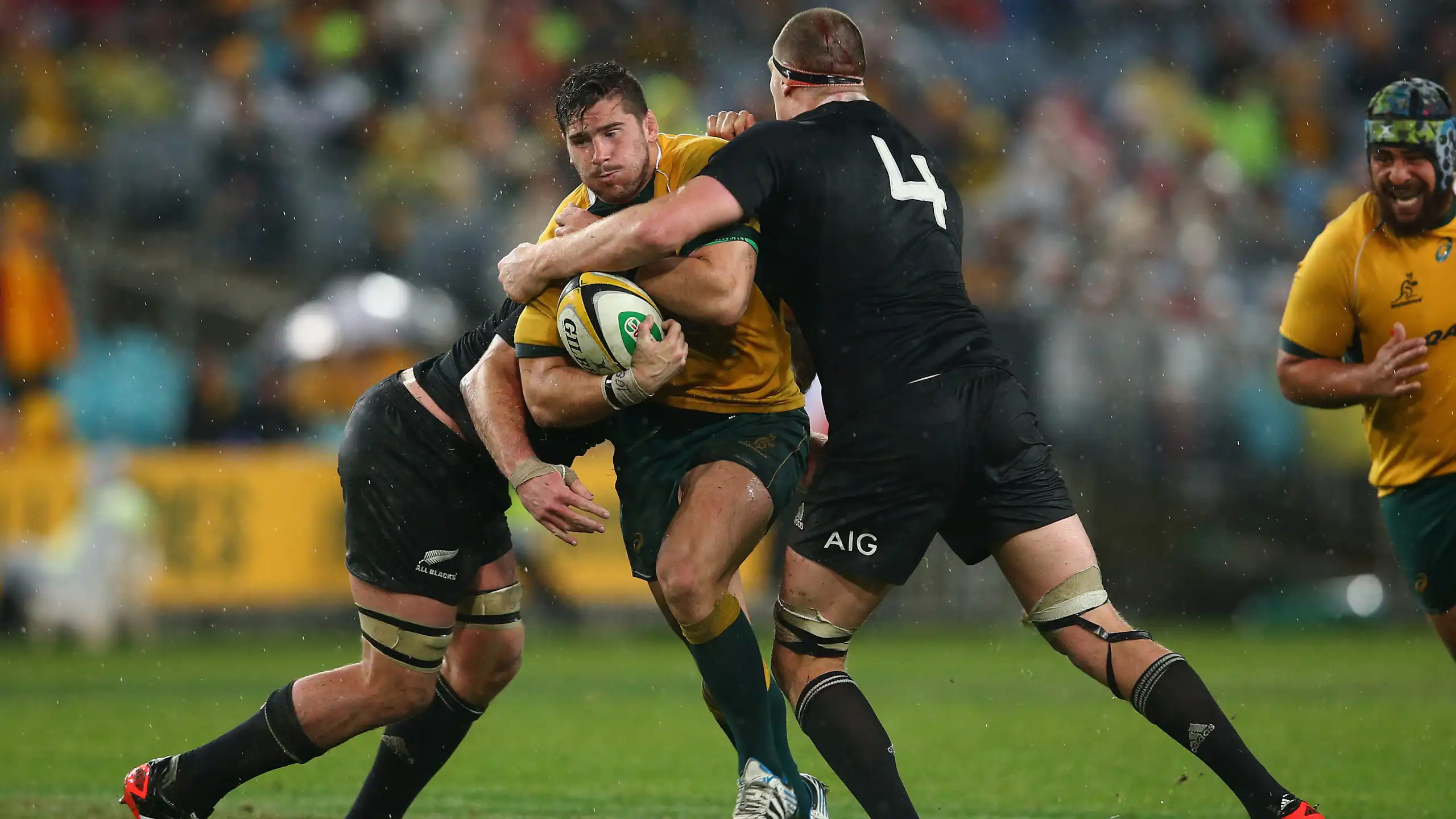 Nathan Charles of the Wallabies is tackled during a game against New Zealand in 2014.