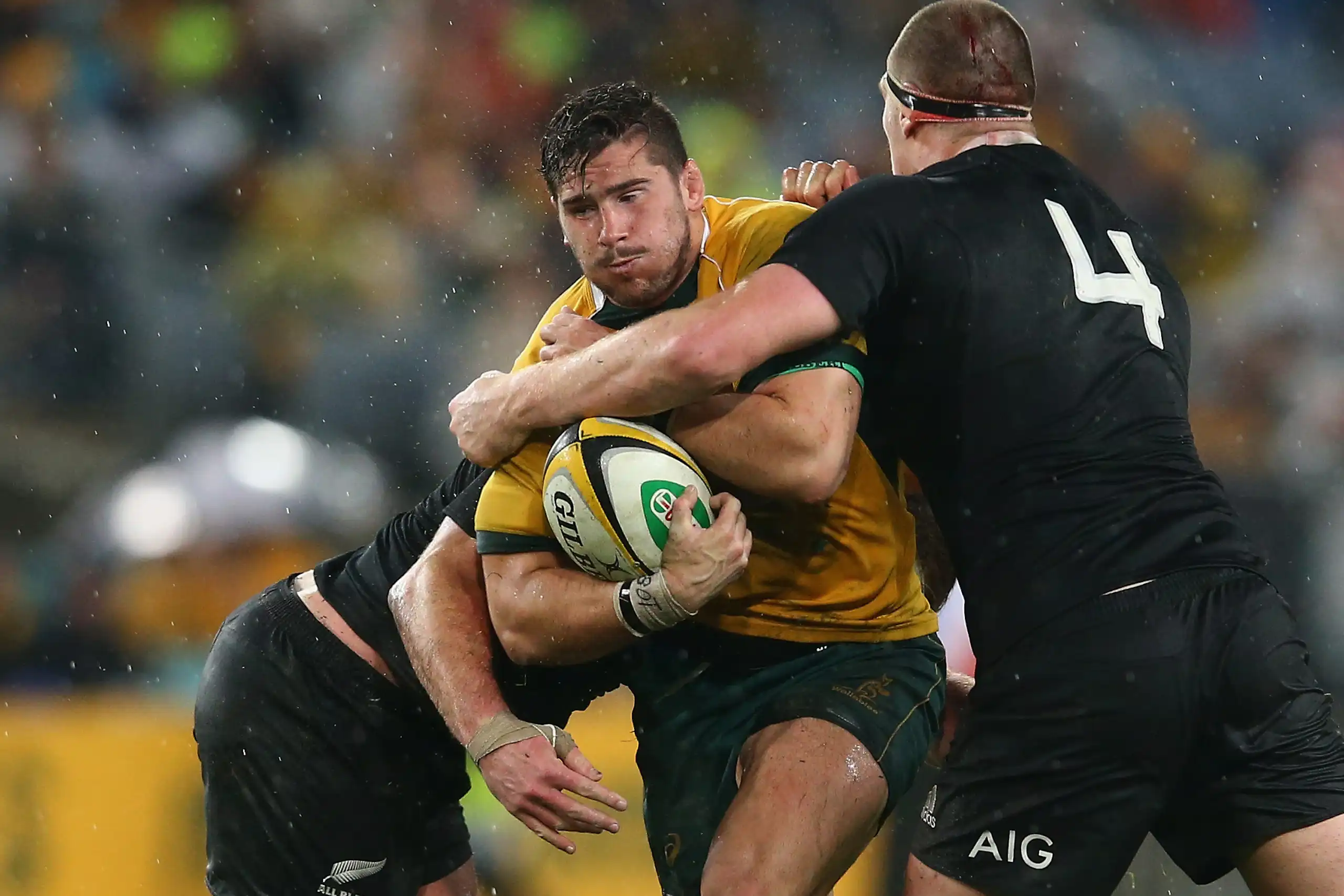 Nathan Charles of the Wallabies is tackled during a game against New Zealand in 2014.