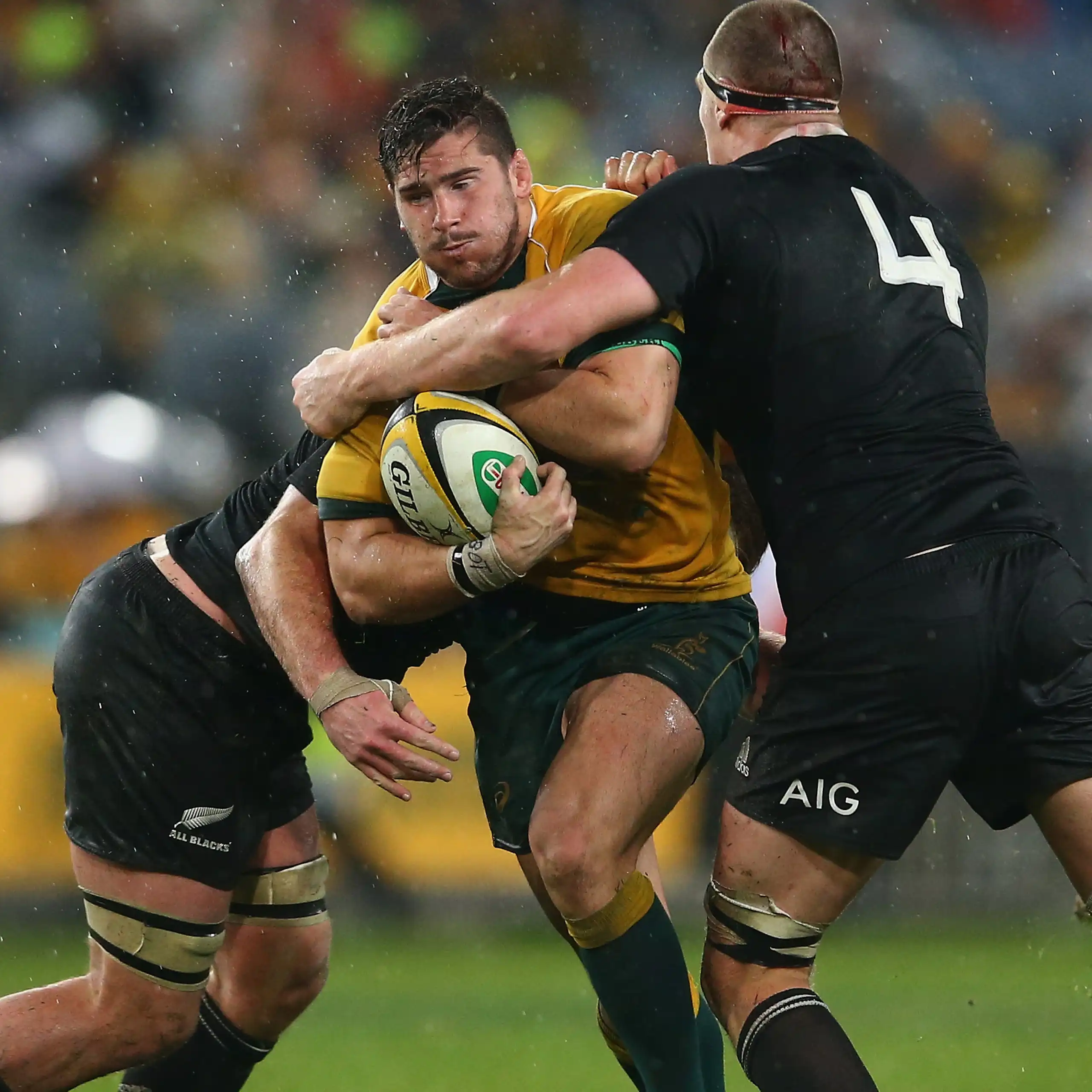 Nathan Charles of the Wallabies is tackled during a game against New Zealand in 2014.
