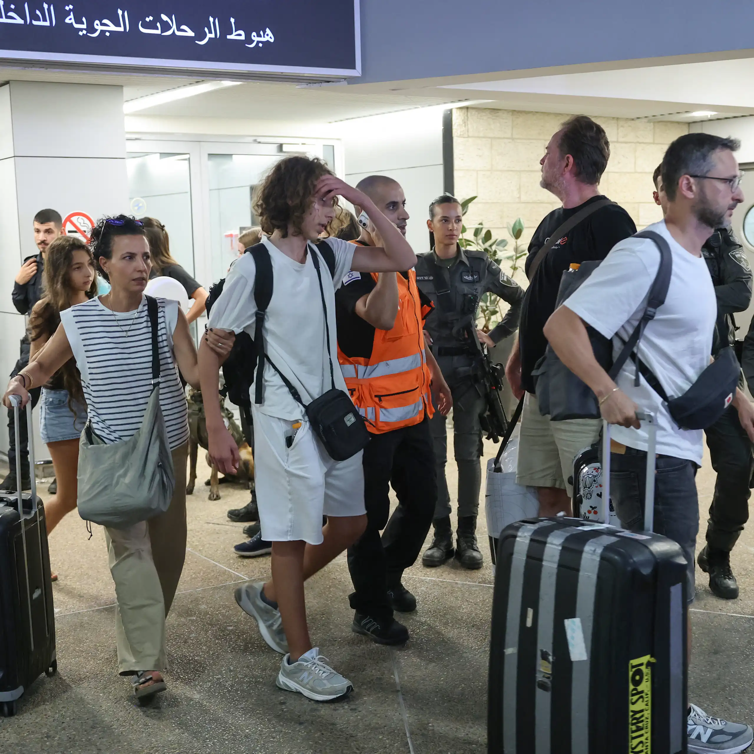 Passengers from a diverted flydubai flight are seen arriving at Ben Gurion Airport in Tel Aviv.