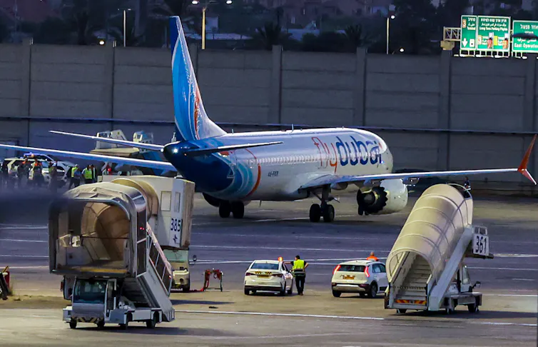 A Flydubai plane seen parked at an airport terminal.