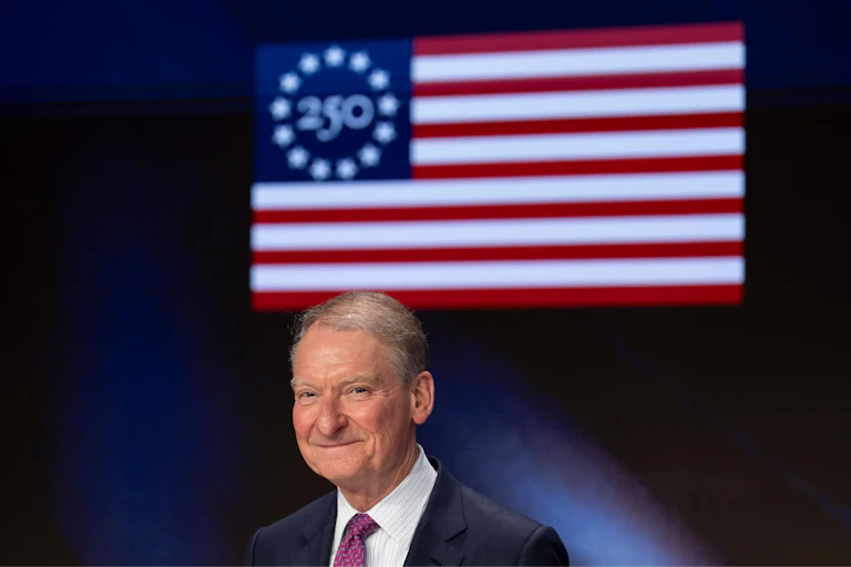 The chair of the Securities and Exchange Commission, Paul Atkins, poses during a closing bell ceremony at the Nasdaq, with an American flag behind him.