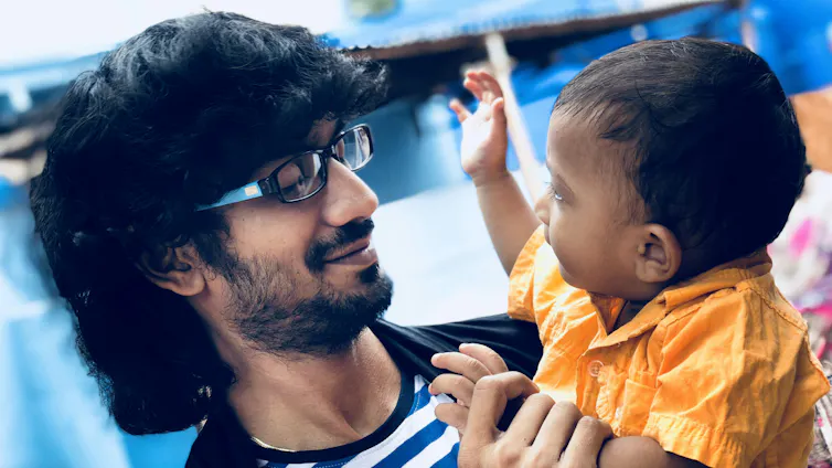 A father seen looking at his toddler.