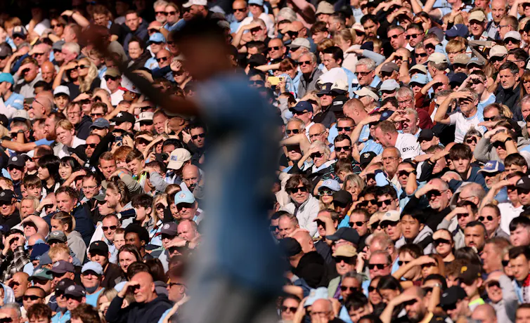 Fans watch on during a Manchester City game.