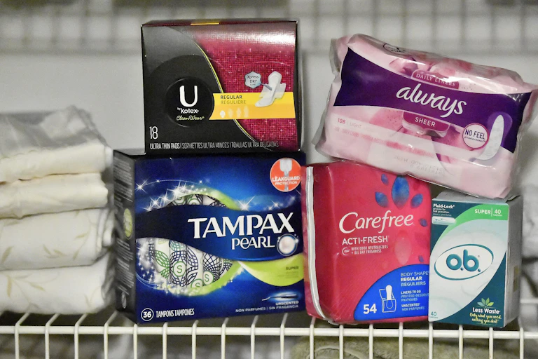 A selection of tampons and pads on a shelf