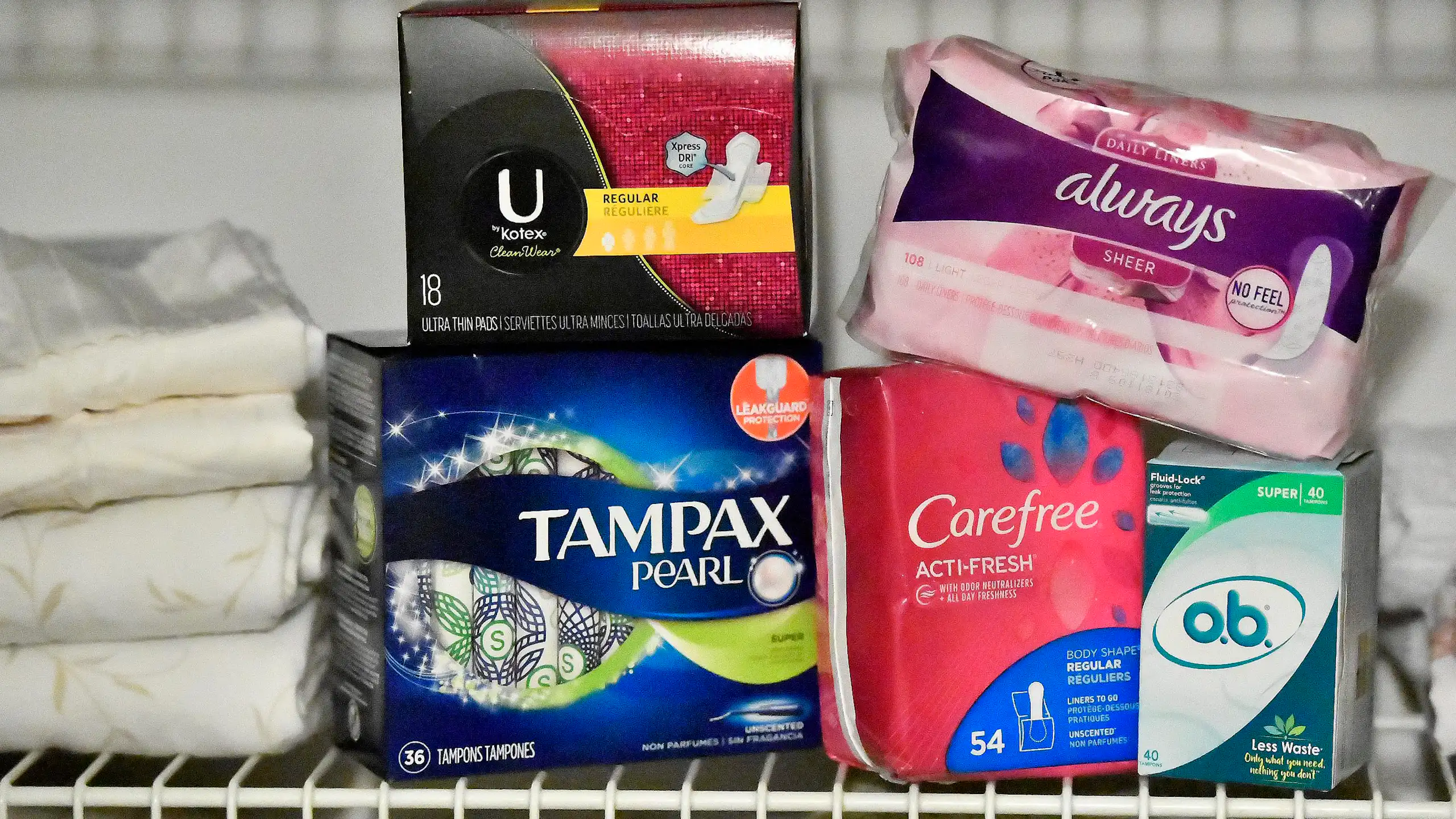 A selection of tampons and pads on a shelf